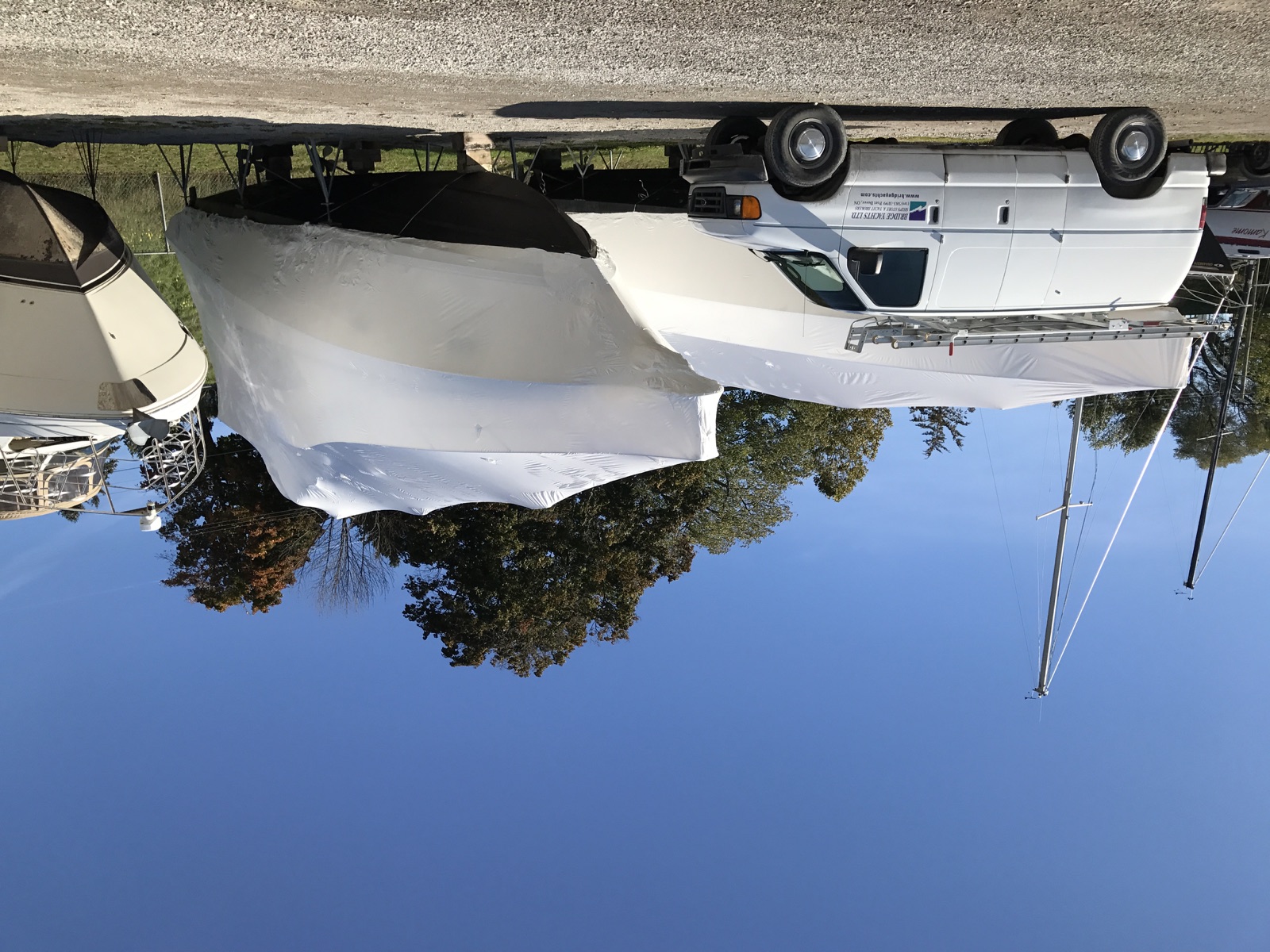Shrink-wrapped boats prepared for winter storage by Bridge Yachts in Port Dover